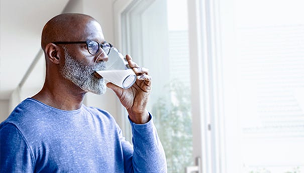 Man drinking a glass of milk