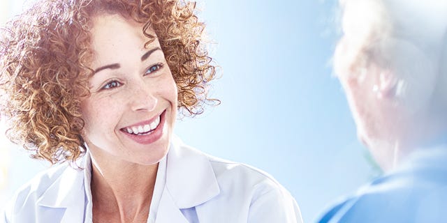 Healthcare Professional Talking To Patient