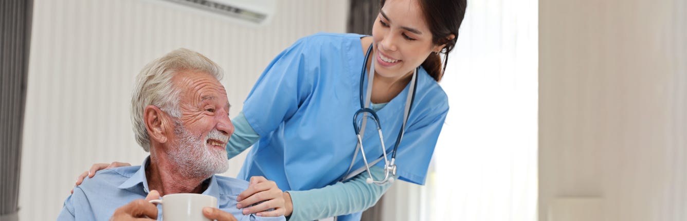 Nurse with patient drinking coffee