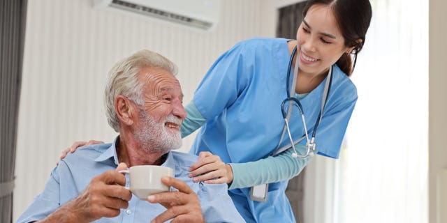 Nurse with patient drinking coffee