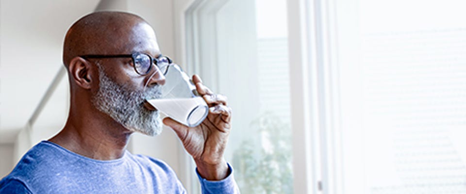 Man drinking a glass of milk